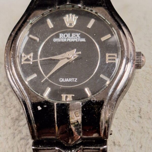 Replica Rolex Quartz ladies watch with black dial and steel bracelet.