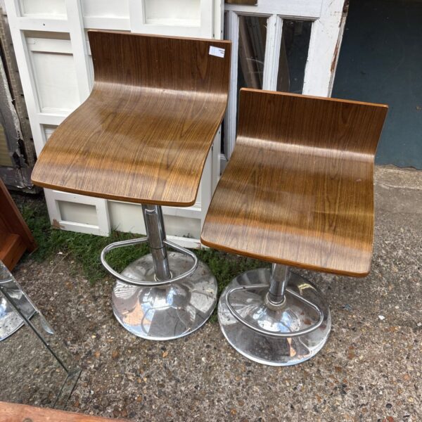 Pair of vintage chrome bar stools with wooden seats.