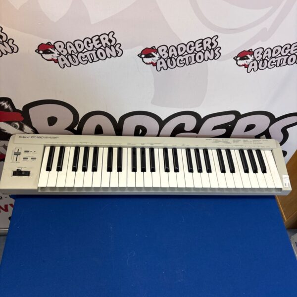 Vintage Roland PC-180 mini keyboard controller for music production.