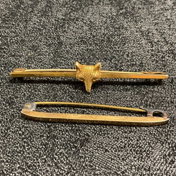 Vintage rolled gold tie pin featuring a detailed fox head design.