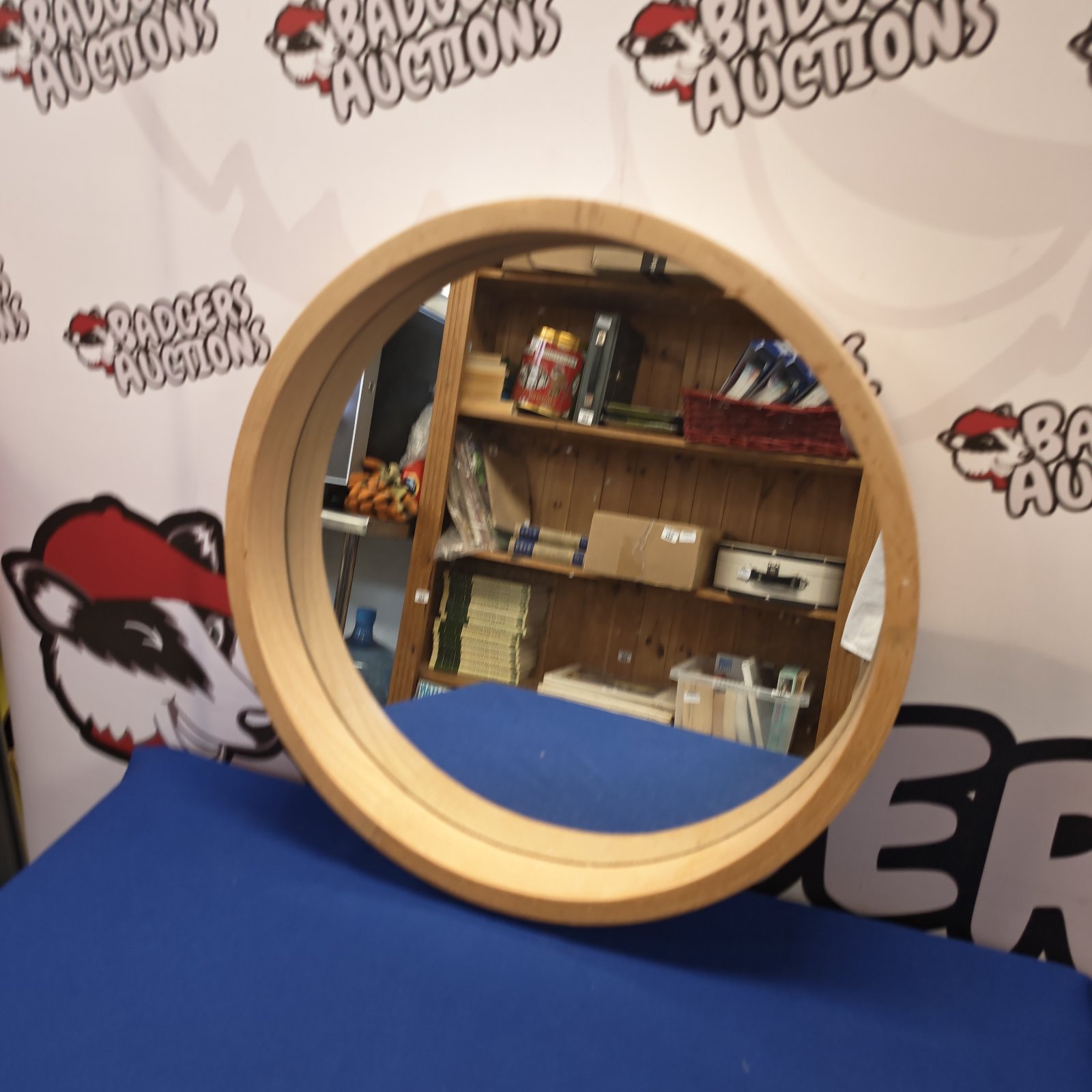 Vintage round wall mirror with a pine frame.