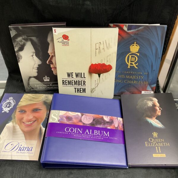 Overview of royal coin collection with albums and coins.