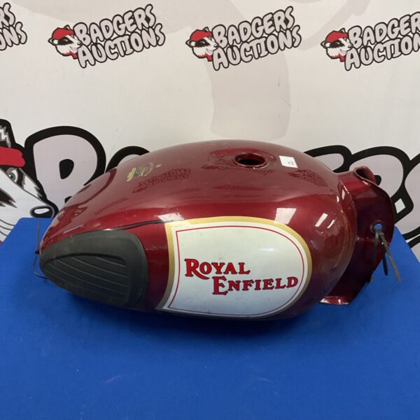 Vintage Royal Enfield fuel tank with holes, classic motorcycle part.