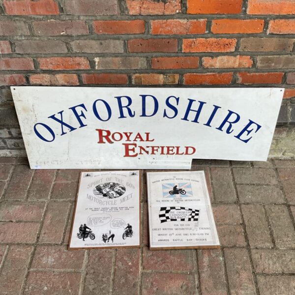 Vintage Royal Enfield sign with motorcycle meet posters.
