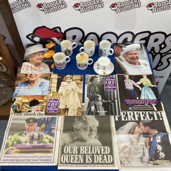 Collection of Royal Memorabilia including mugs and books.