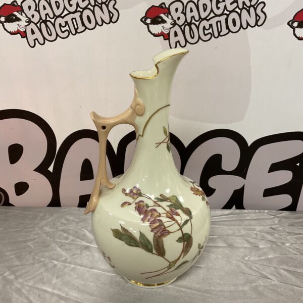 Antique Royal Worcester ewer with floral decoration and gilt rim.