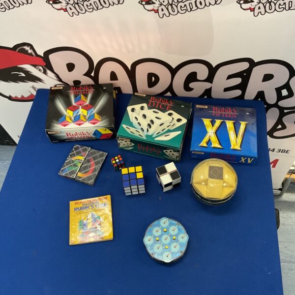 Vintage Rubik's Cube lot with assorted puzzles and original boxes.