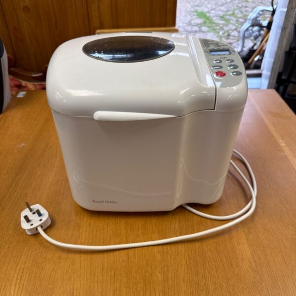 White Russell Hobbs bread making machine on a wooden surface.