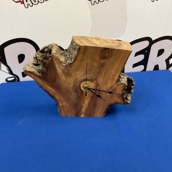 Handmade rustic wood clock with natural wood grain.