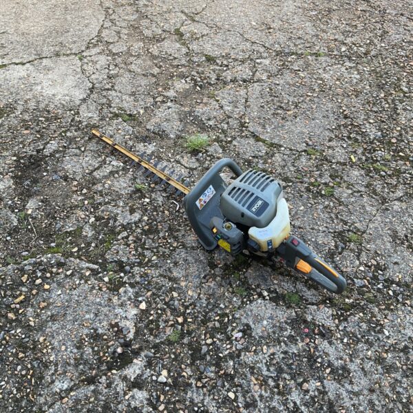 Ryobi petrol hedge cutter for garden maintenance and landscaping.
