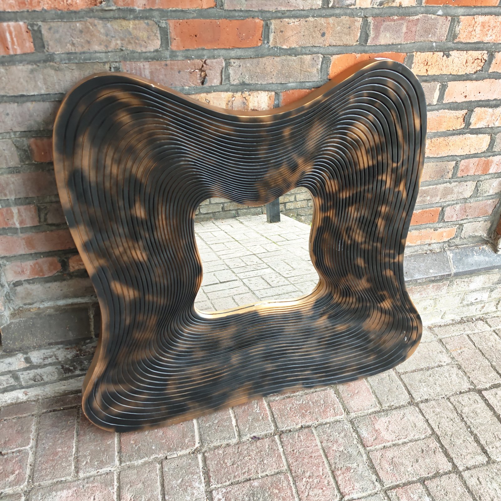 Unique Salvador Dali style mirror with layered design.
