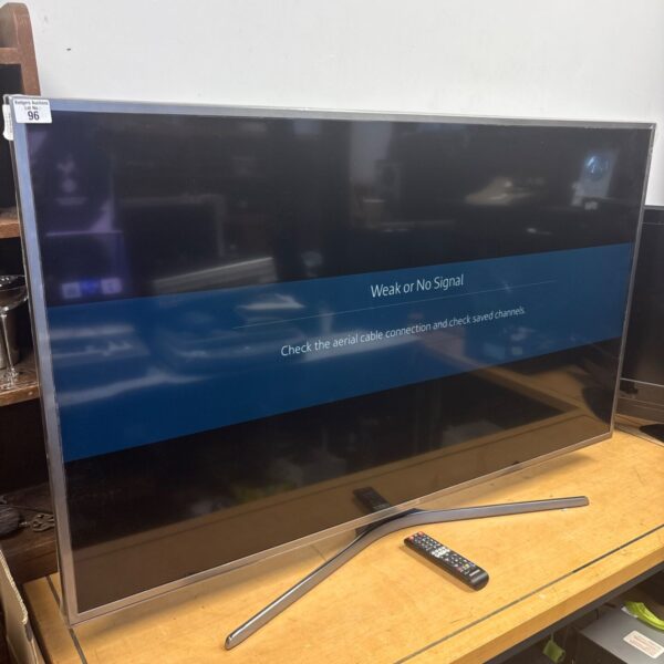 Samsung 55 inch smart TV with remote control.