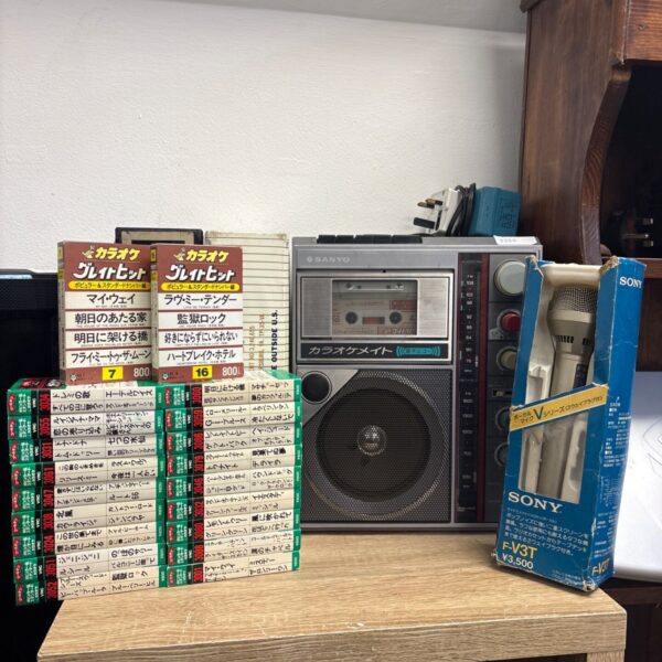 Vintage Sanyo Karaoke Mate with Japanese music cassettes.