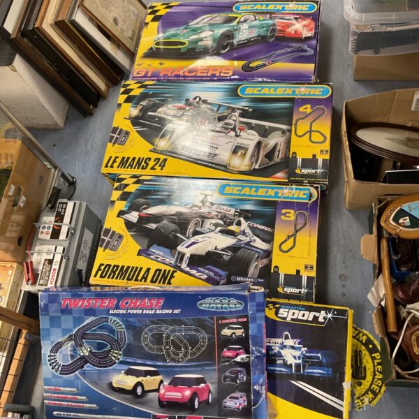 Lot of five Scalextric racing sets for model car enthusiasts.