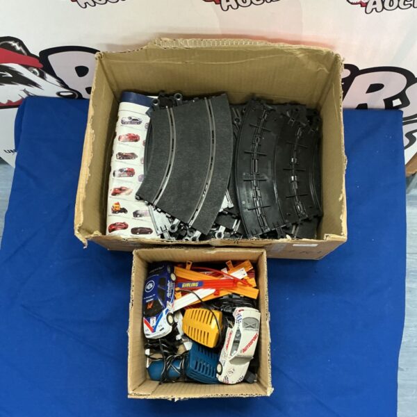Box of Scalextric track and cars for model racing.
