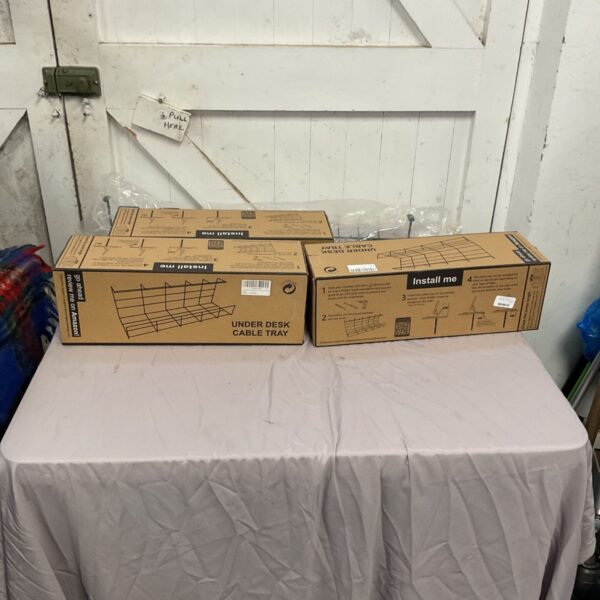 Three Scandinavian under desk cable trays for effective cable management.