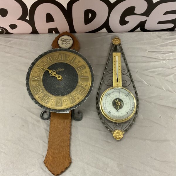 Vintage Schatz quartz clock and Shortland barometer on a wall.