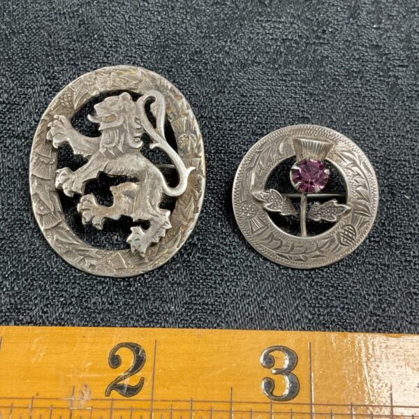 Two sterling silver Scottish brooches, a lion and a thistle.
