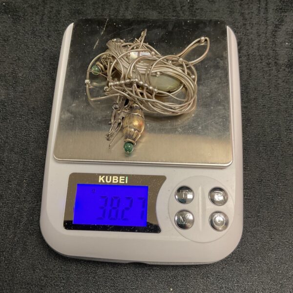 Scrap silver jewellery lot with chain and pendants.