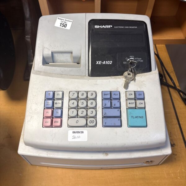 Vintage Sharp XE-A102 cash register with keys, side view.