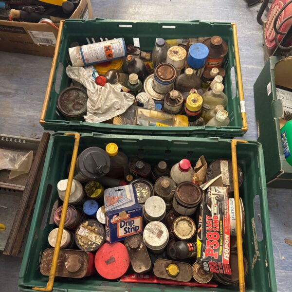 Tray of mixed shed clearance chemicals and workshop fluids.