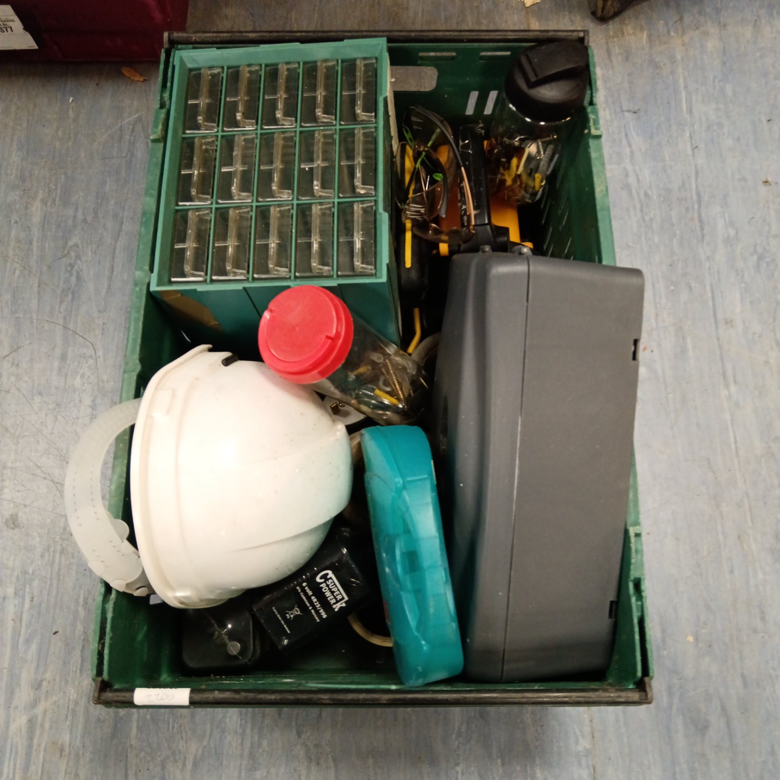 Shed clearance lot with plastic drawers, hard hat and tools.
