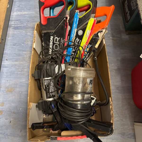 Shed clearance tool lot with saws, lamp and compressor.