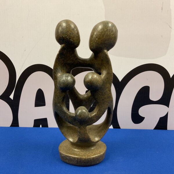 Abstract Shona sculpture depicting a family group in stone.