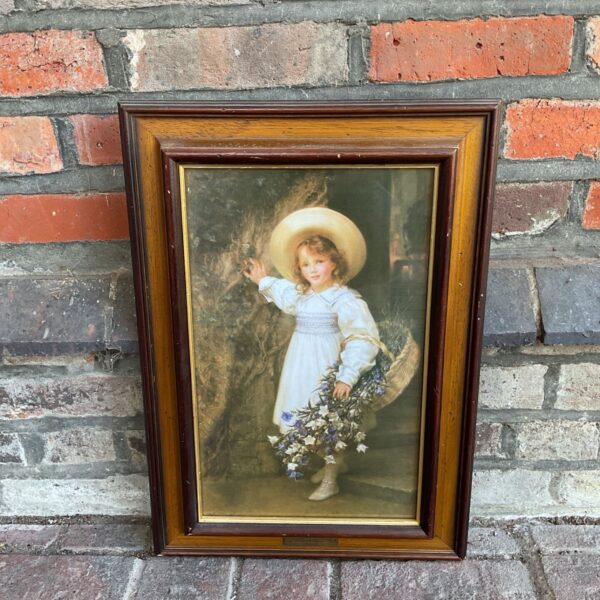 Framed Sigismund Goetze print of a young flower girl with flowers.