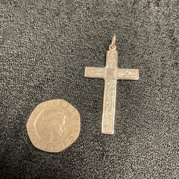 Detailed silver Celtic cross pendant with intricate knotwork design.