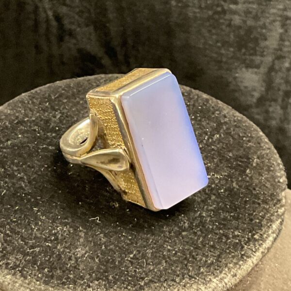 Silver ring with pale blue chalcedony stone, modernist design.