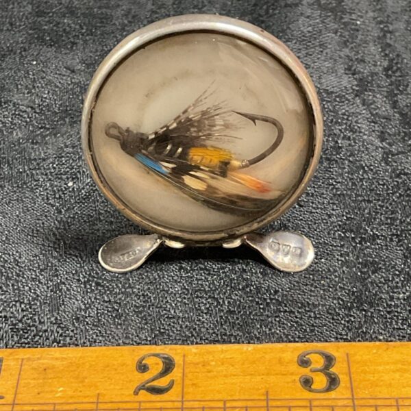 Antique silver place card holder with a fishing fly design.