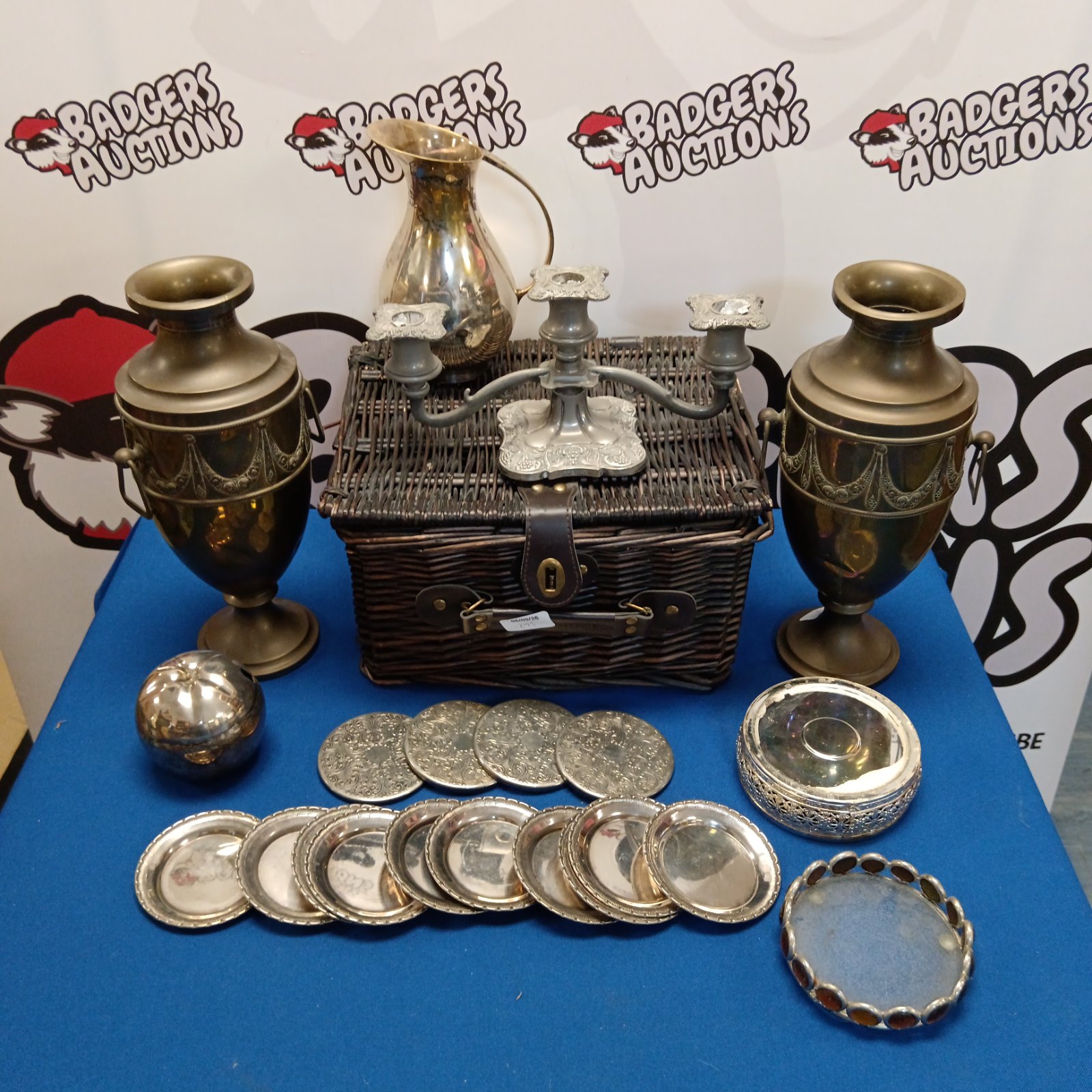 Vintage silver plate basket with coasters and dishes.