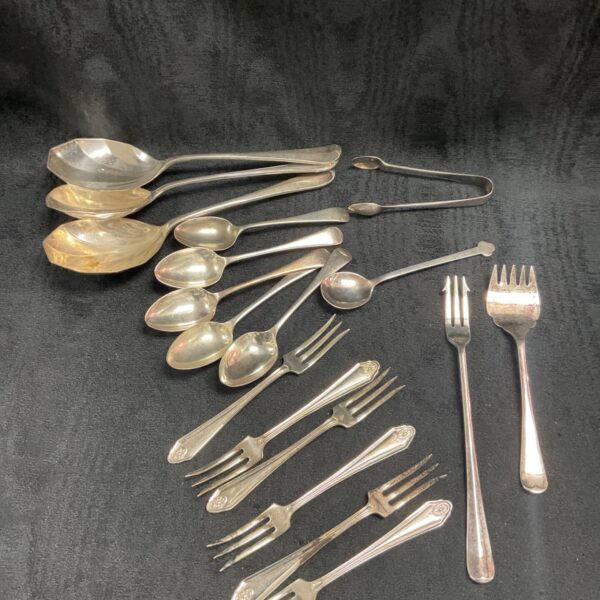 Vintage silver plate cutlery set with spoons and forks.