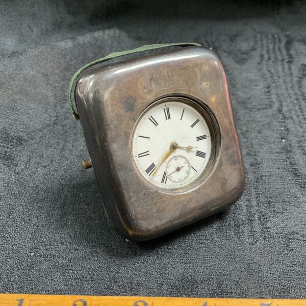 Antique silver pocket watch in its travel case.