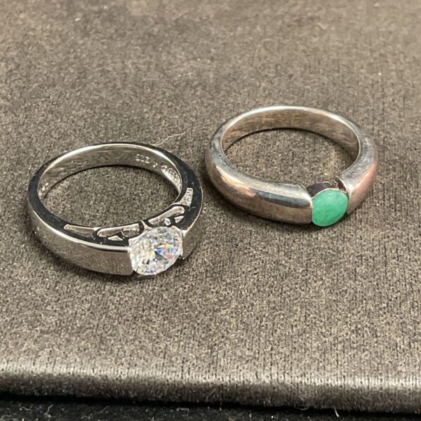Two silver rings with white and green stones, size N.