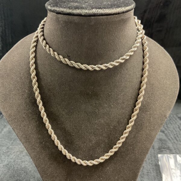 Silver rope chain necklace displayed on a jewelry bust.