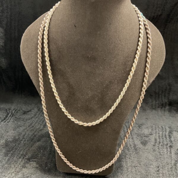 Two silver rope twist necklaces on a display bust.