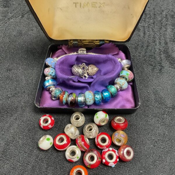Silverado 925 silver bracelet with colourful glass beads and floral charms.