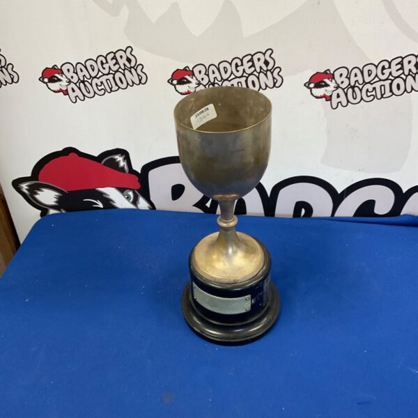 Vintage silverplate trophy with engraved details, a collectible sports award.