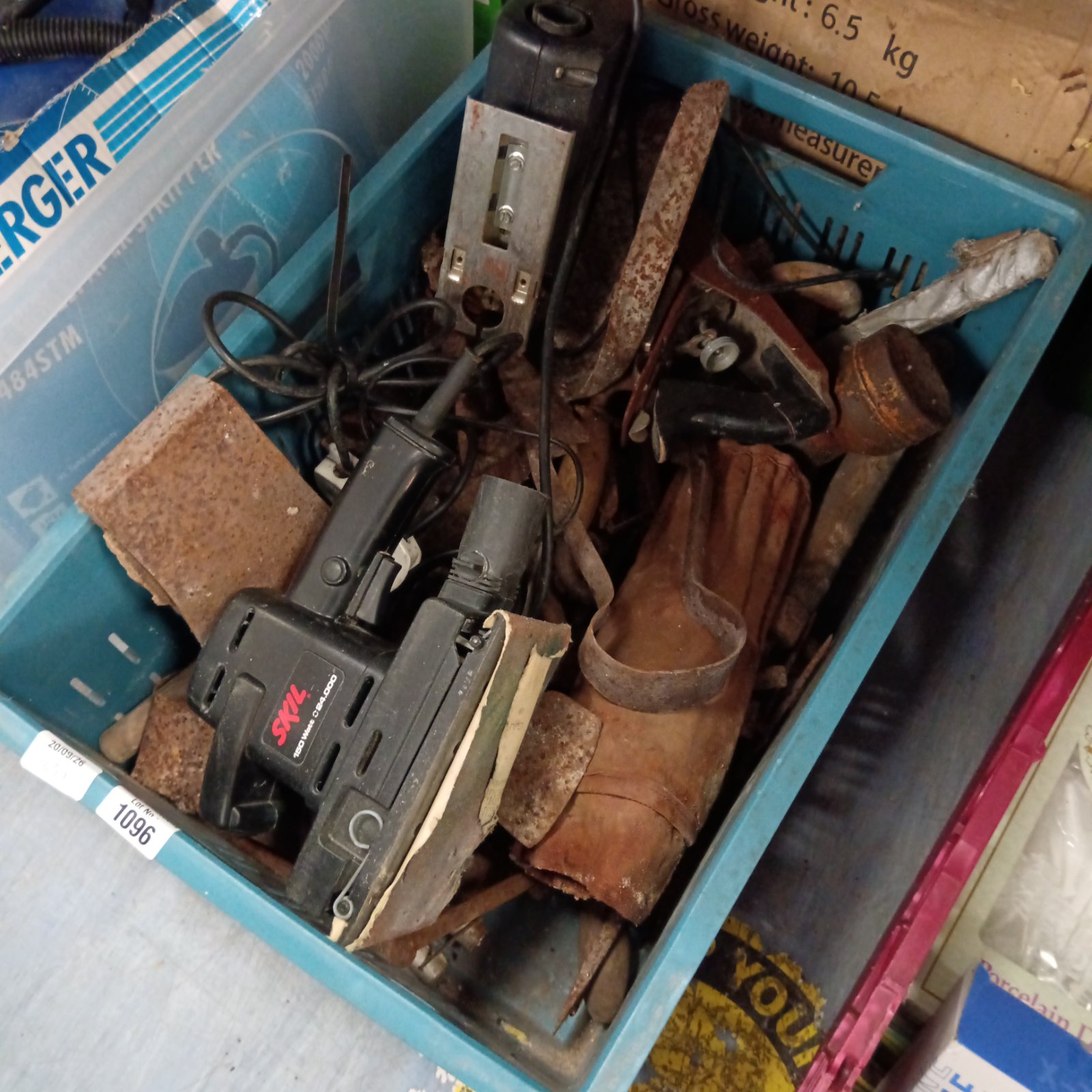 Vintage Skil circular saw within a box of mixed tools.
