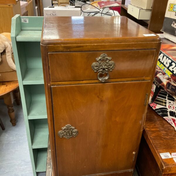 Small walnut cabinet with decorative moulding, vintage storage solution.