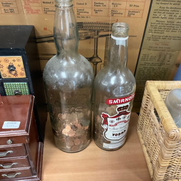 Vintage Smirnoff vodka bottle with coins inside.