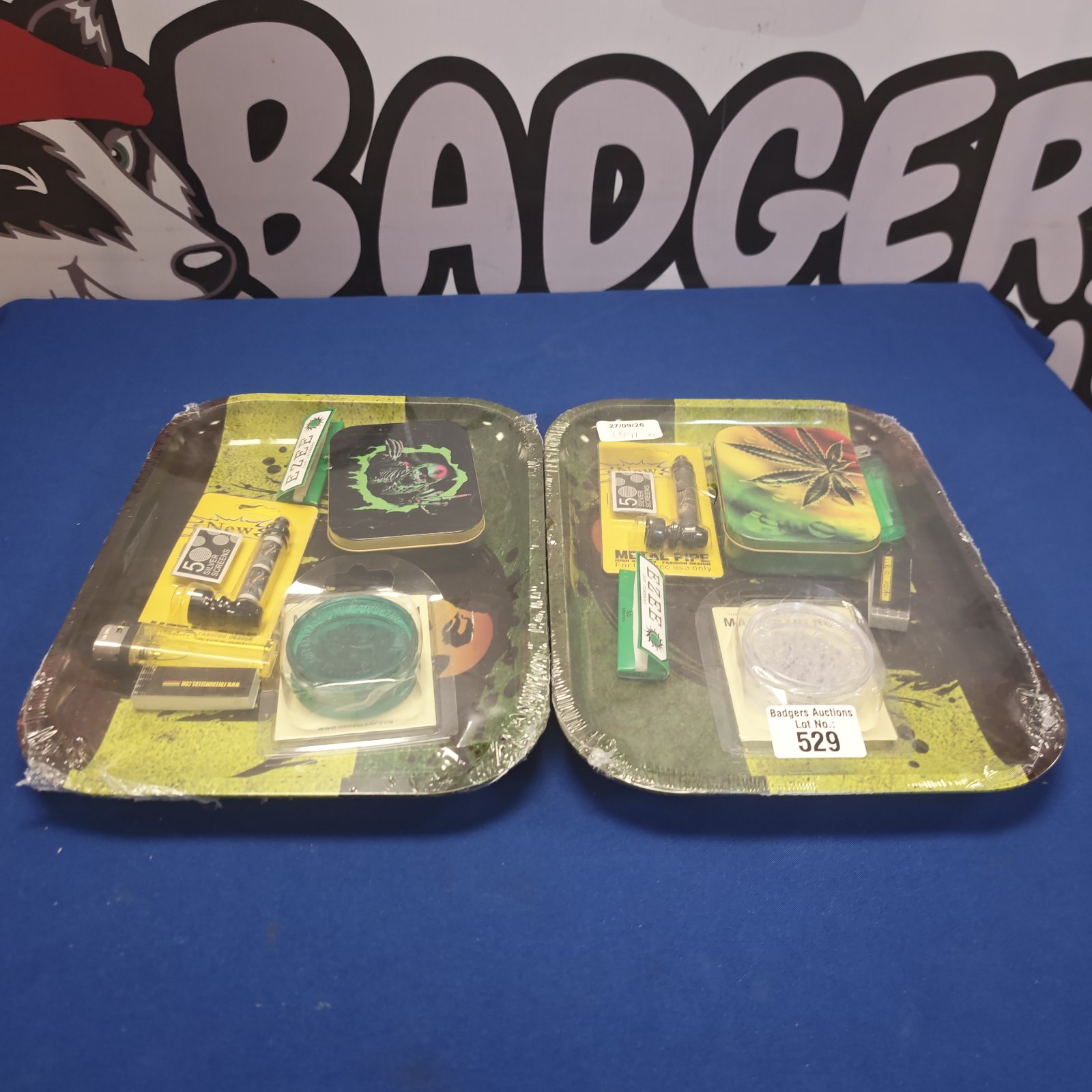 Sealed smoker's accessory packs with metal pipe and rolling papers.