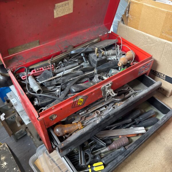 Full view of a red Snap On tool box filled with tools.