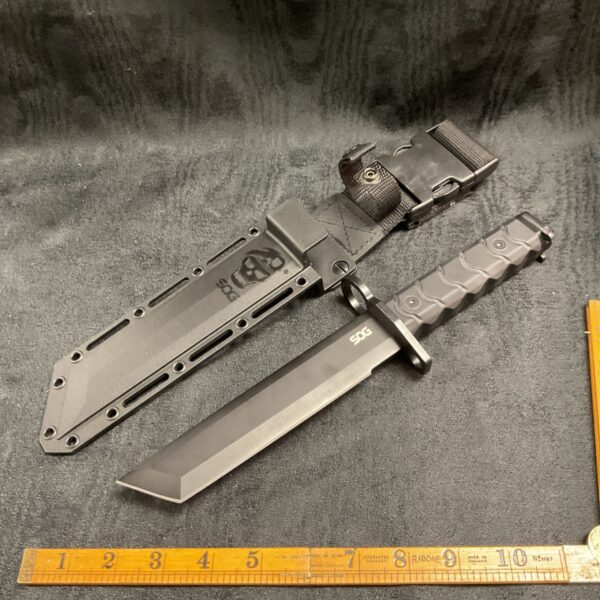 SOG Combat knife with black blade and sheath.