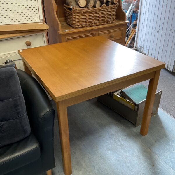 Solid oak extending dining table in a home setting.