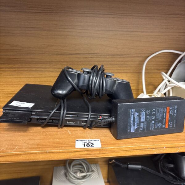 Sony PS2 Slim console with controller and power supply.