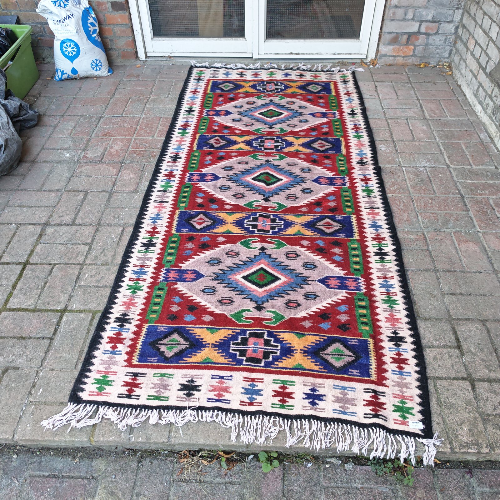 Vibrant South American alpaca rug with geometric pattern.