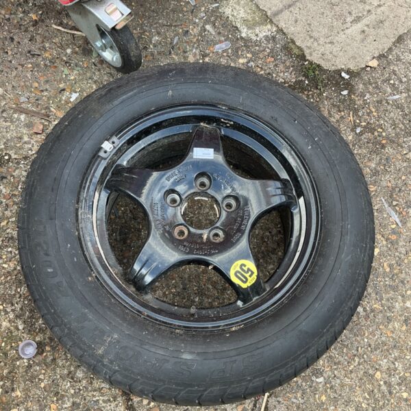 Used 225x60xR16 spare wheel with alloy rim for vehicle replacement.